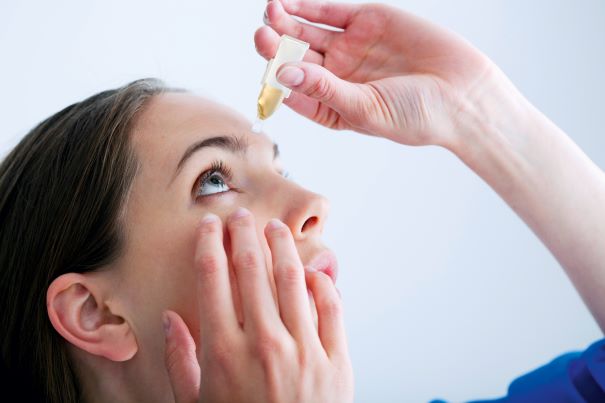 Woman uses serum eye drops